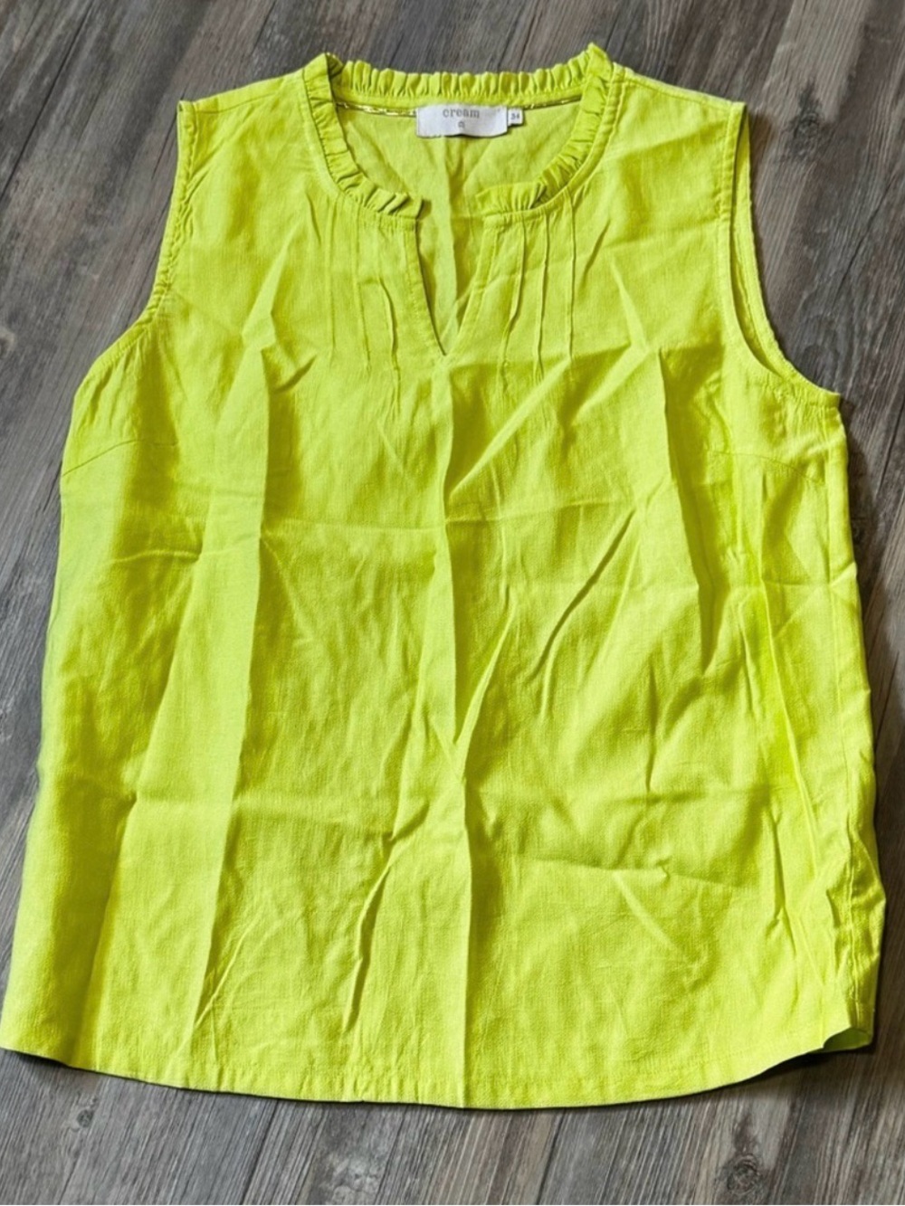 Cream blouse featuring a V-neck with a ruffled standing collar.